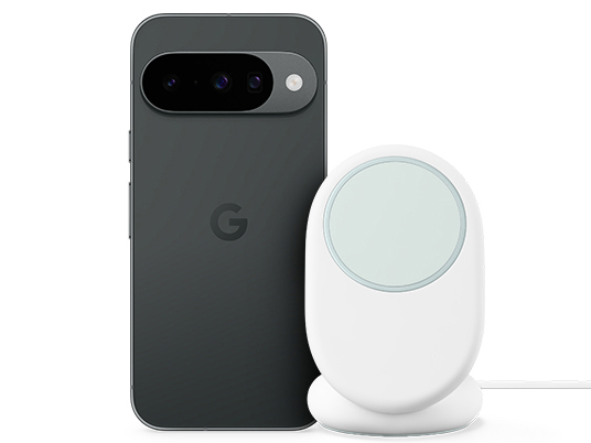 Ein dunkelgraues Google Pixel Handy neben einem weißen kabellosen Ladeständer.