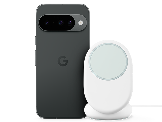 Ein dunkelgraues Google Pixel Handy neben einem weißen kabellosen Ladegerät.