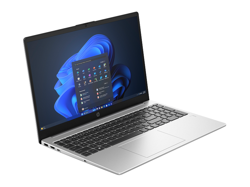 Ezüst HP laptop nyitva, Windows 11 start menüvel és billentyűzettel.