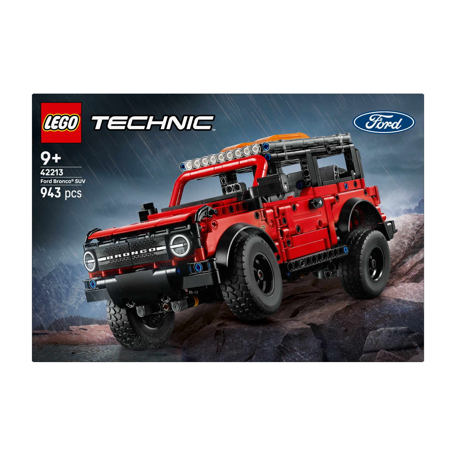 Lego Technic Ford Bronco SUV rosso su terreno roccioso con pioggia sullo sfondo.
