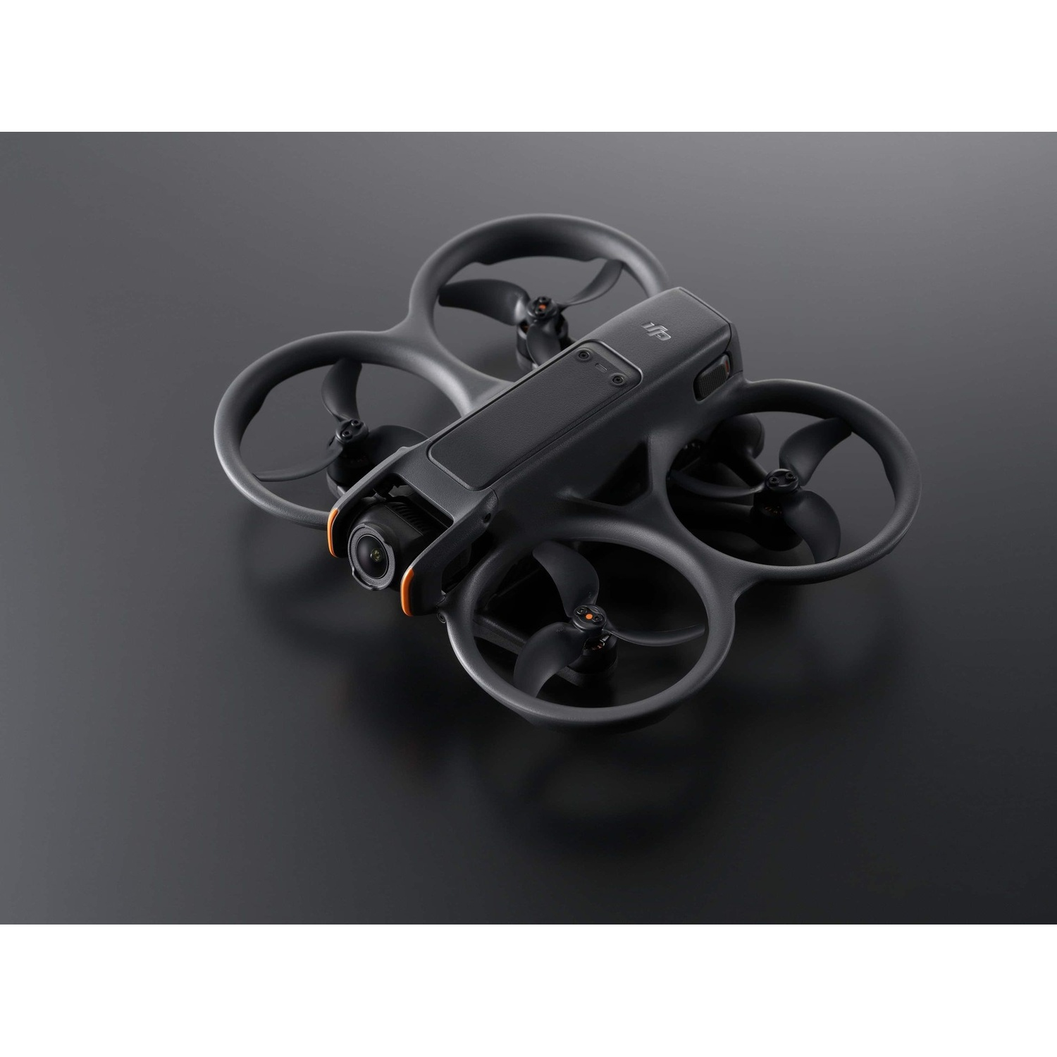 A black DJI Avata drone with propellers is shown on a dark gray surface.