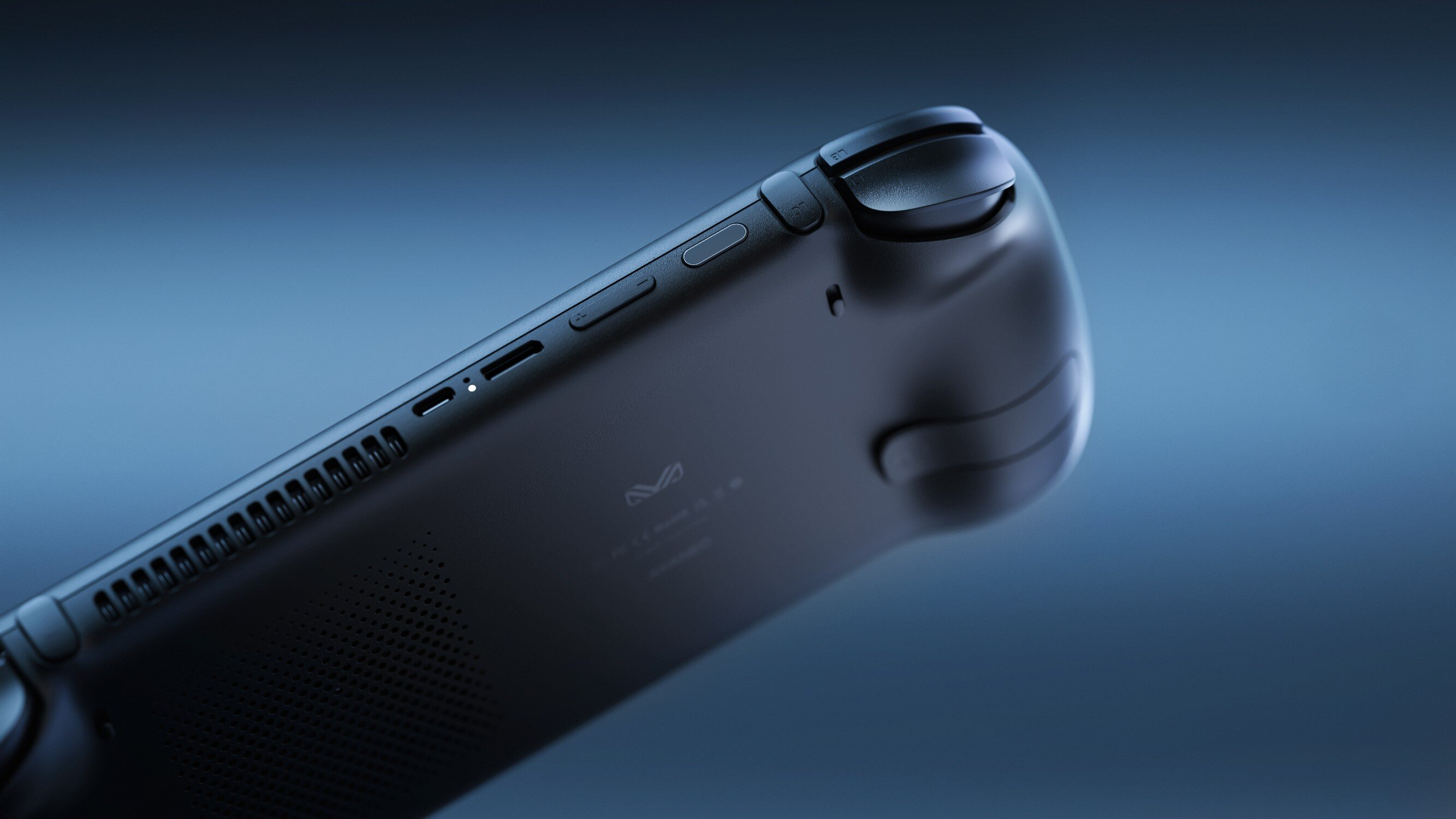 Zbliżenie czarnego kontrolera z otworami wentylacyjnymi i przyciskami na niebieskim tle.