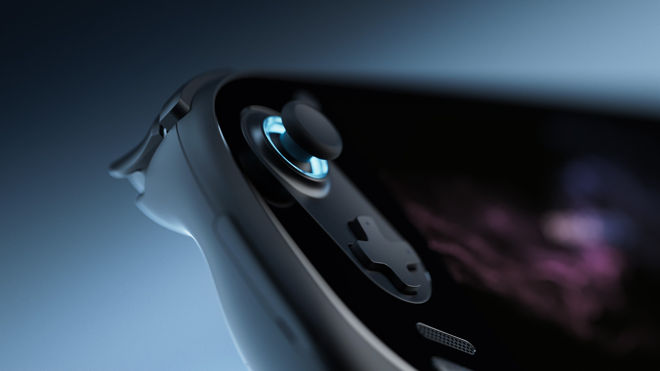 Zbliżenie czarnego kontrolera z niebieskim podświetlanym joystickiem i przyciskami.