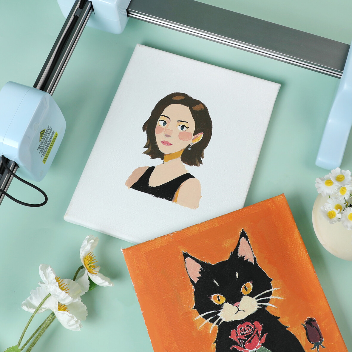 Dipinti di una donna e un gatto accanto a una macchina da taglio.