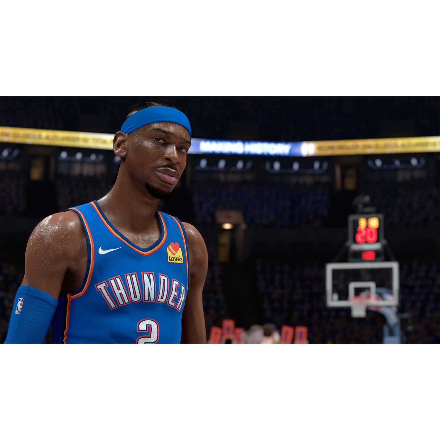 Een basketbalspeler in een blauw shirt met nummer 2, zweet op de huid.