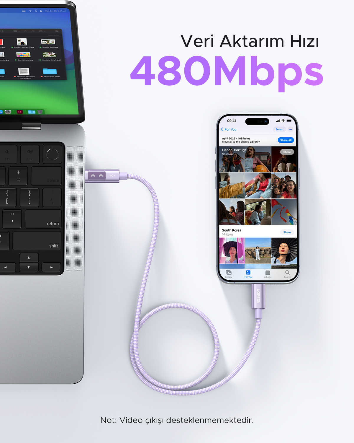 Mor bir kablo, fotoğraf gösteren bir dizüstü bilgisayarı bir akıllı telefona bağlıyor. 480Mbps.