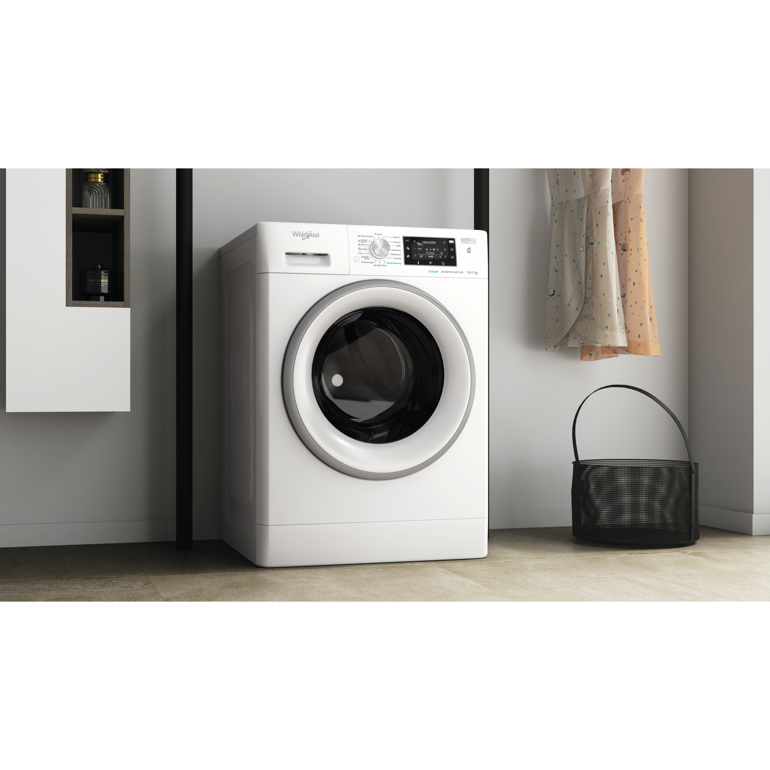 A white washing machine with a black basket and clothes beside it.