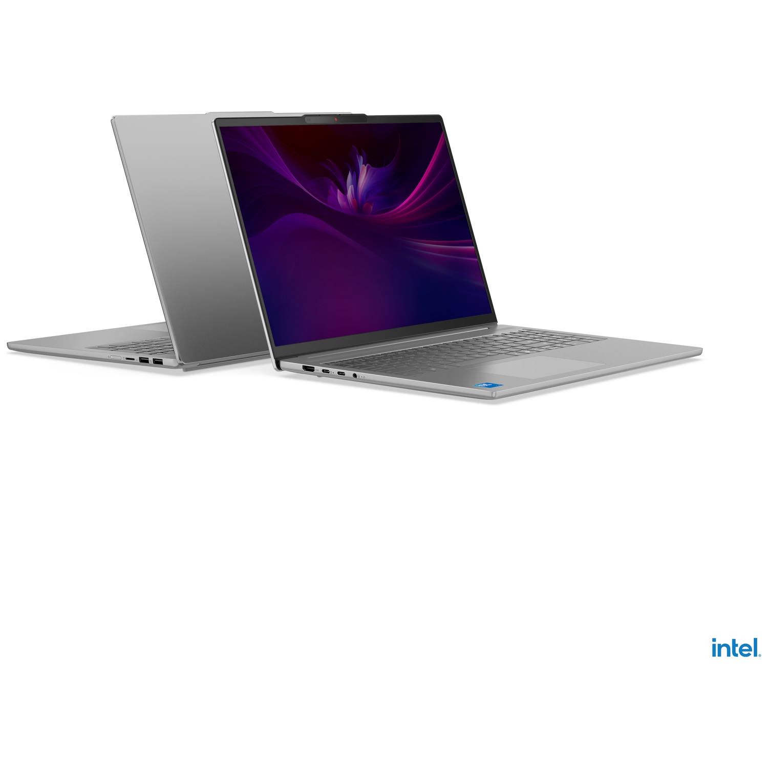 Two silver laptops side-by-side, one open showing a purple wallpaper.