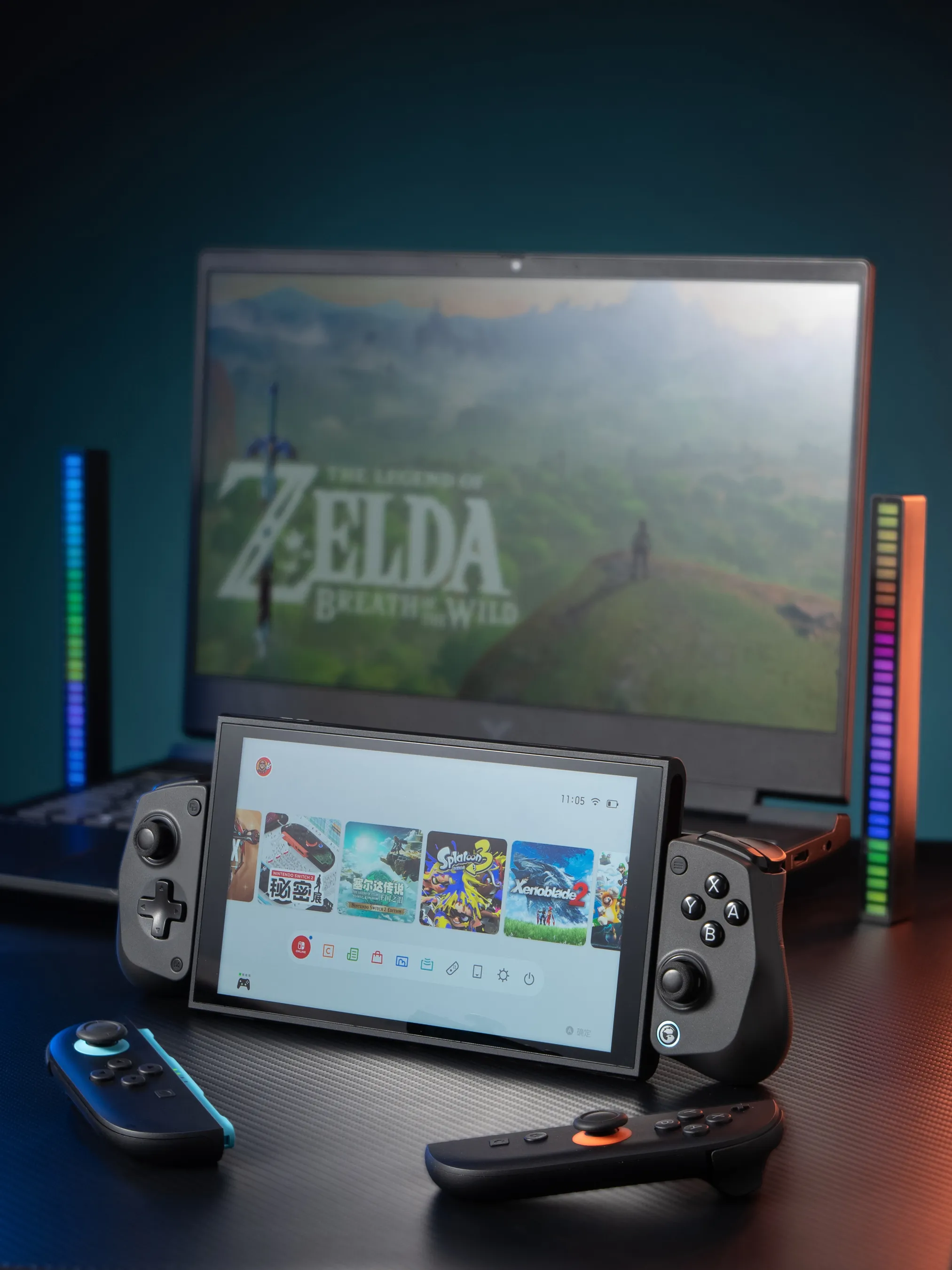 Nintendo Switch con giochi e controller, laptop mostra Zelda