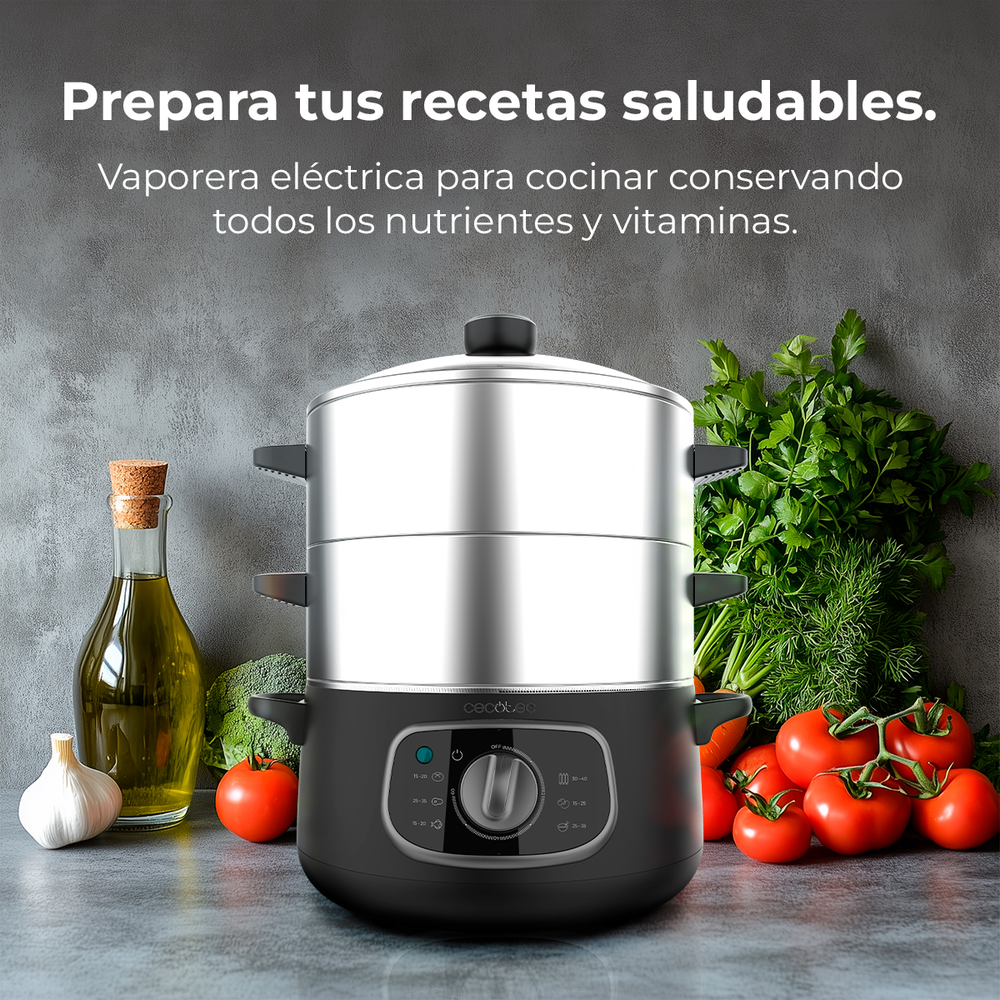 Una vaporera eléctrica de dos niveles con verduras y aceite al lado.
