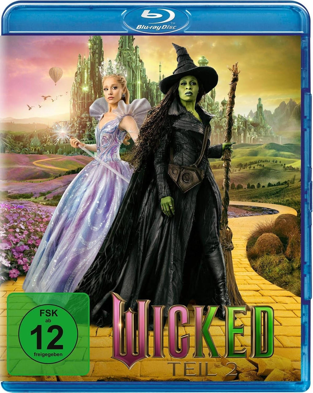 Eine Prinzessin und eine Hexe stehen vor einer Smaragdstadt auf dem Cover von Wicked Teil 2.