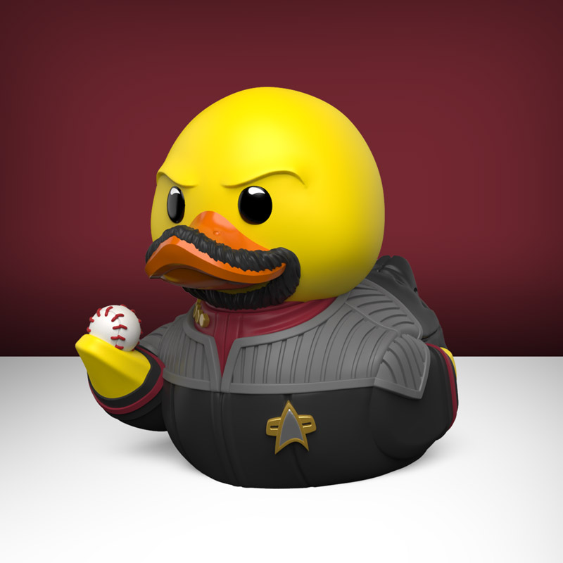 Sárga gumikacsa bajusszal, szakállal és Csillagflotta-egyenruhában, baseballt tart.