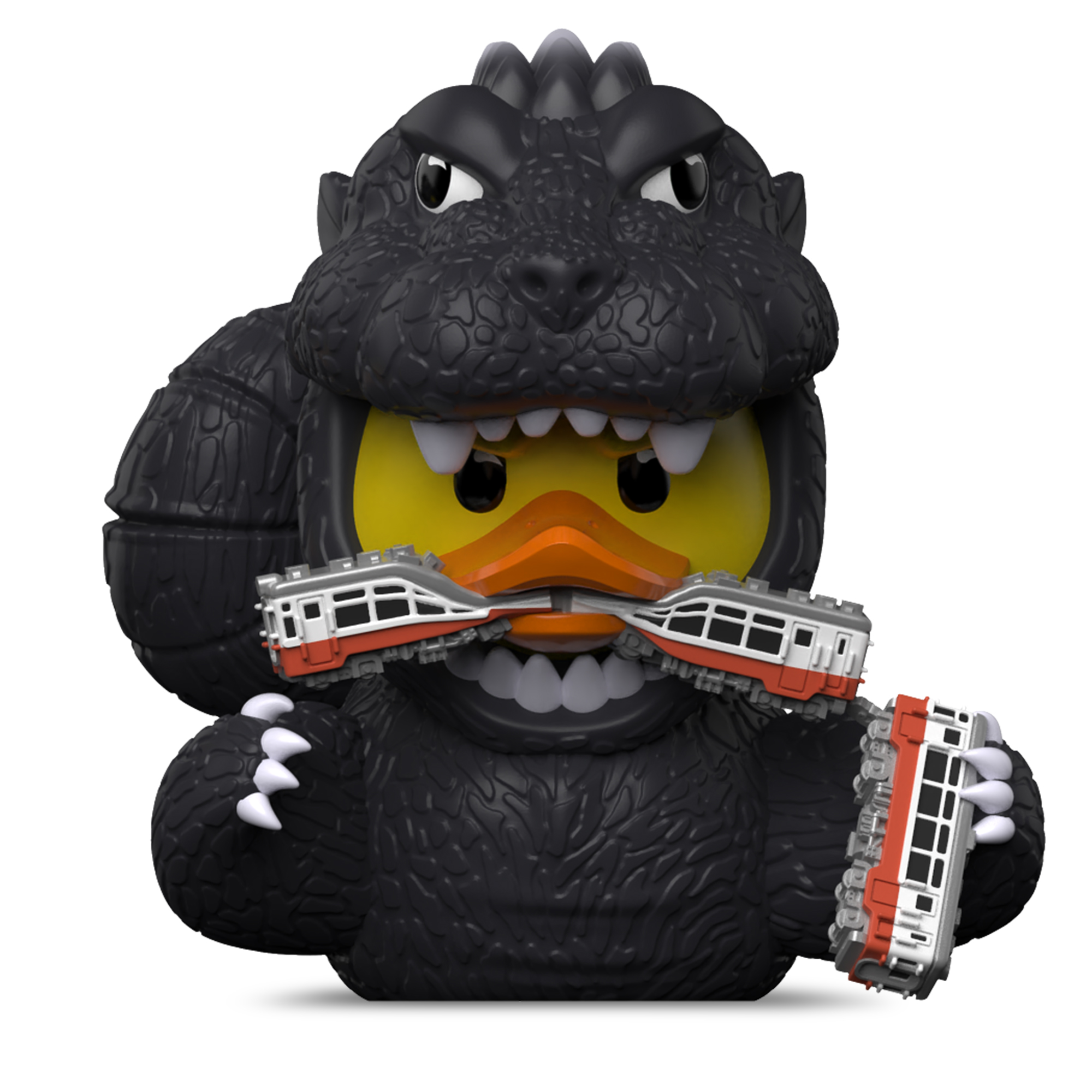 Godzilla gumikacsa két játékvonatot tart és harap beléjük.