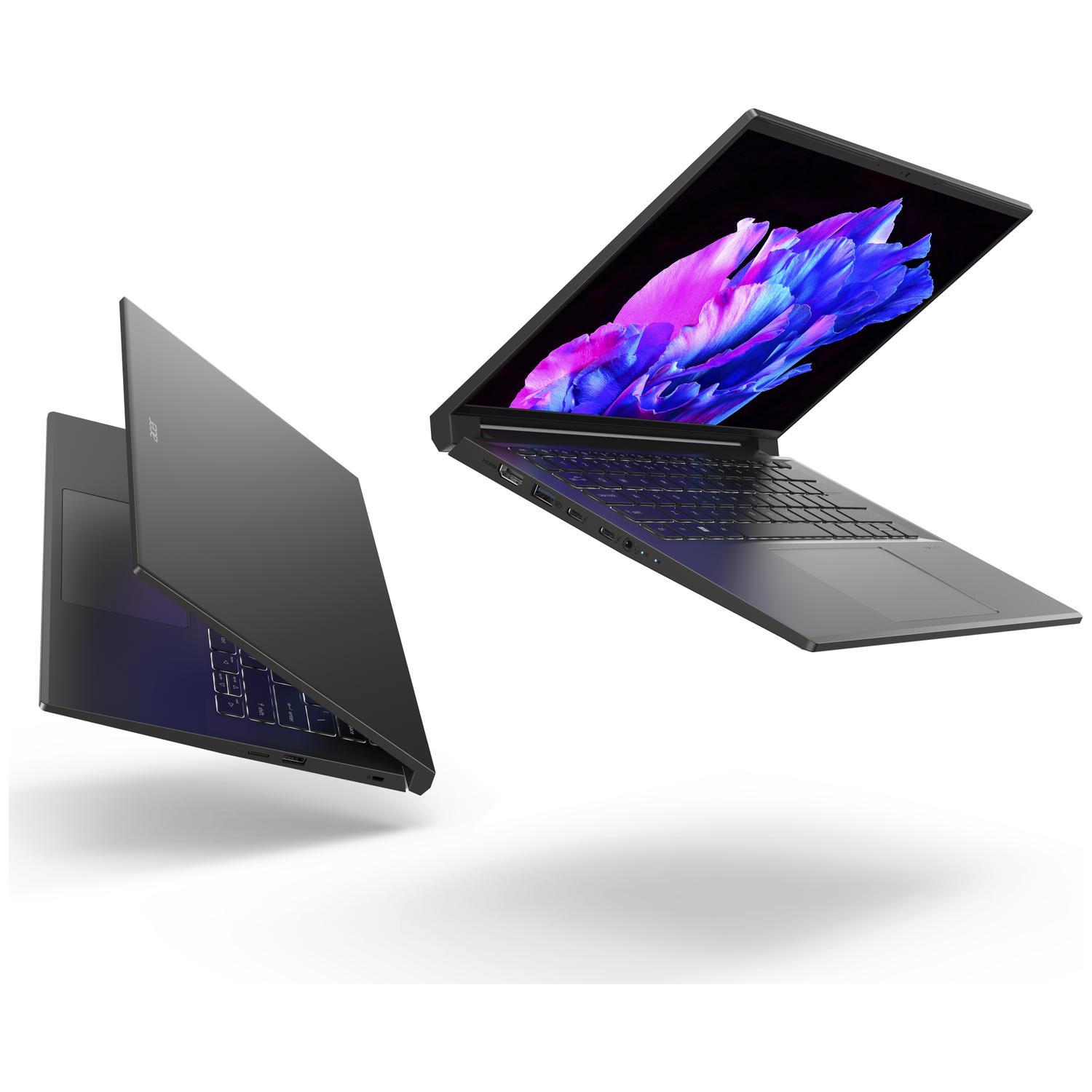 Two gray laptops float, one open displaying a colorful wallpaper.
