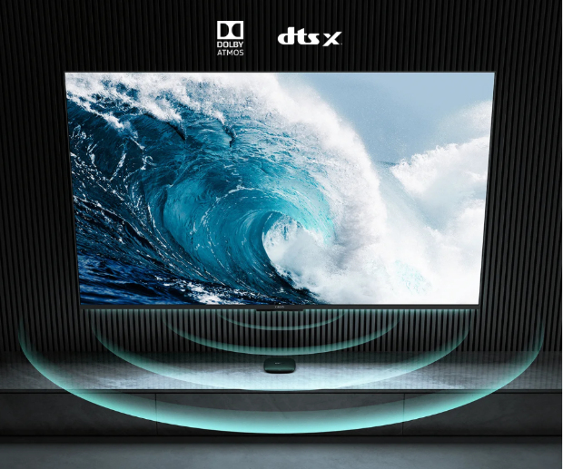 A TV displays a huge wave. Below are Dolby Atmos and DTS:X logos.