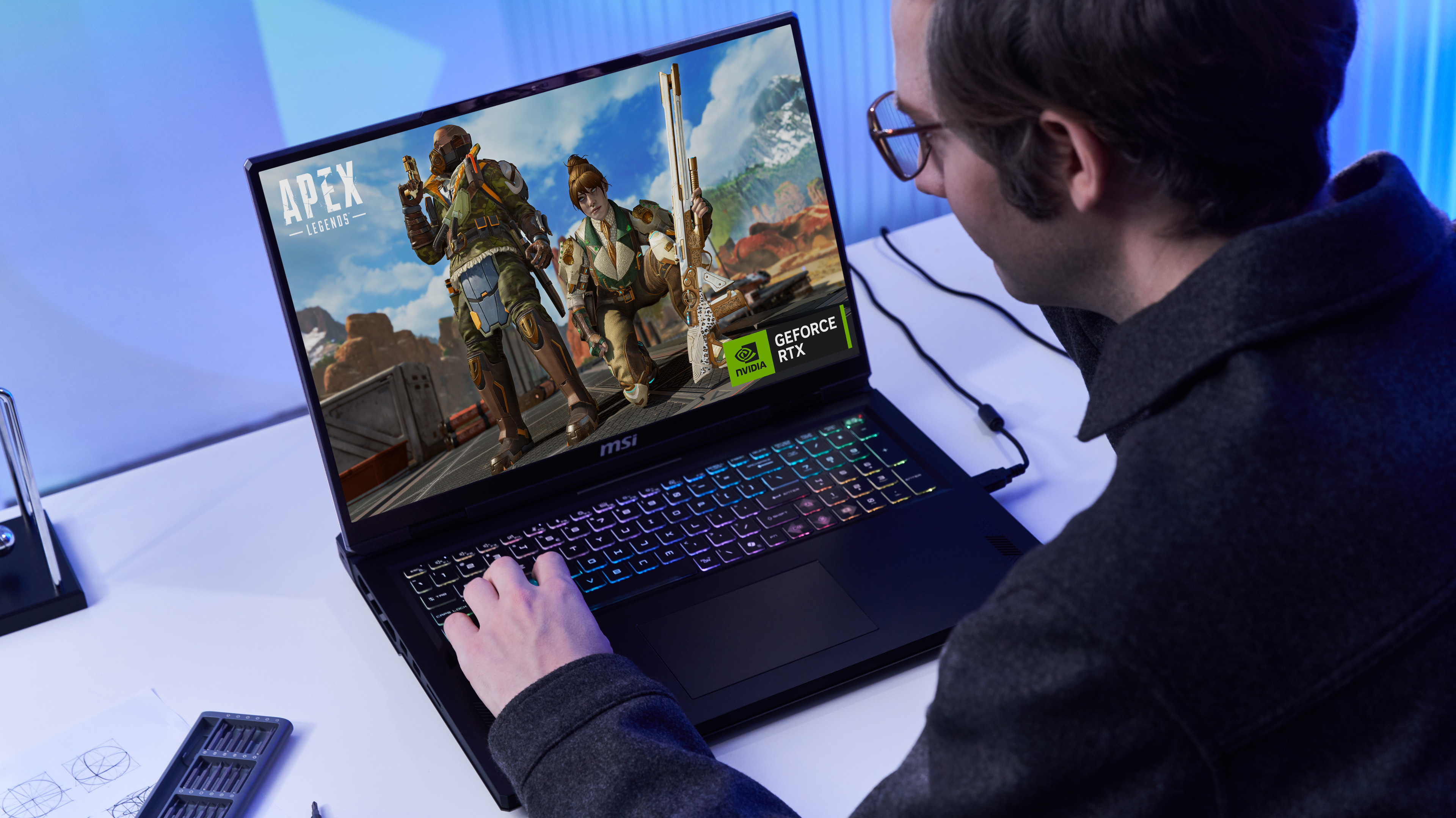 Mann spielt Apex Legends auf MSI-Laptop mit bunter Tastatur. Nvidia-Logo sichtbar.