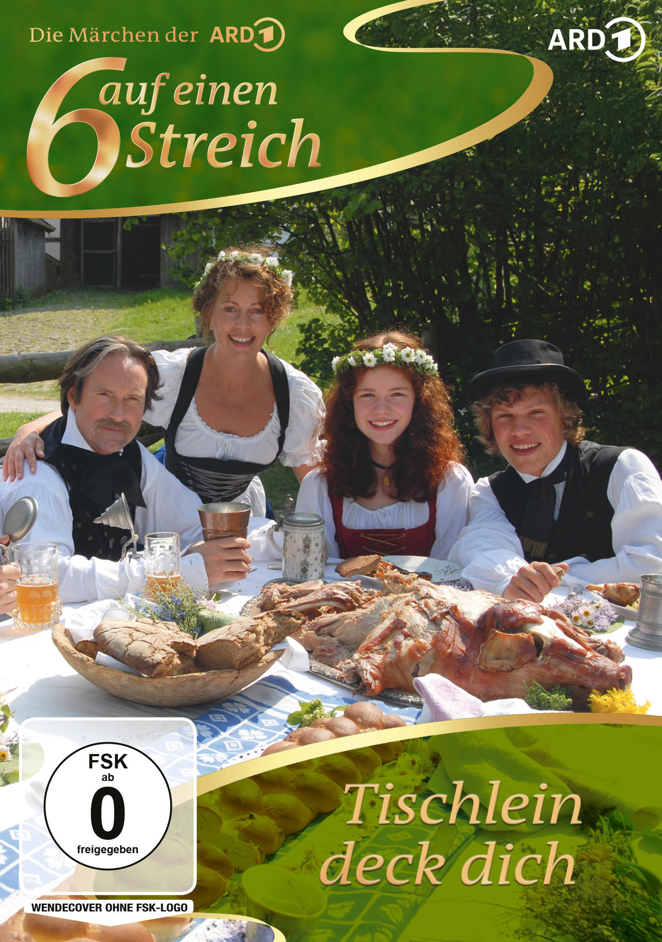 Vier Personen in Tracht sitzen an einem Tisch mit einem Festessen und Bier.