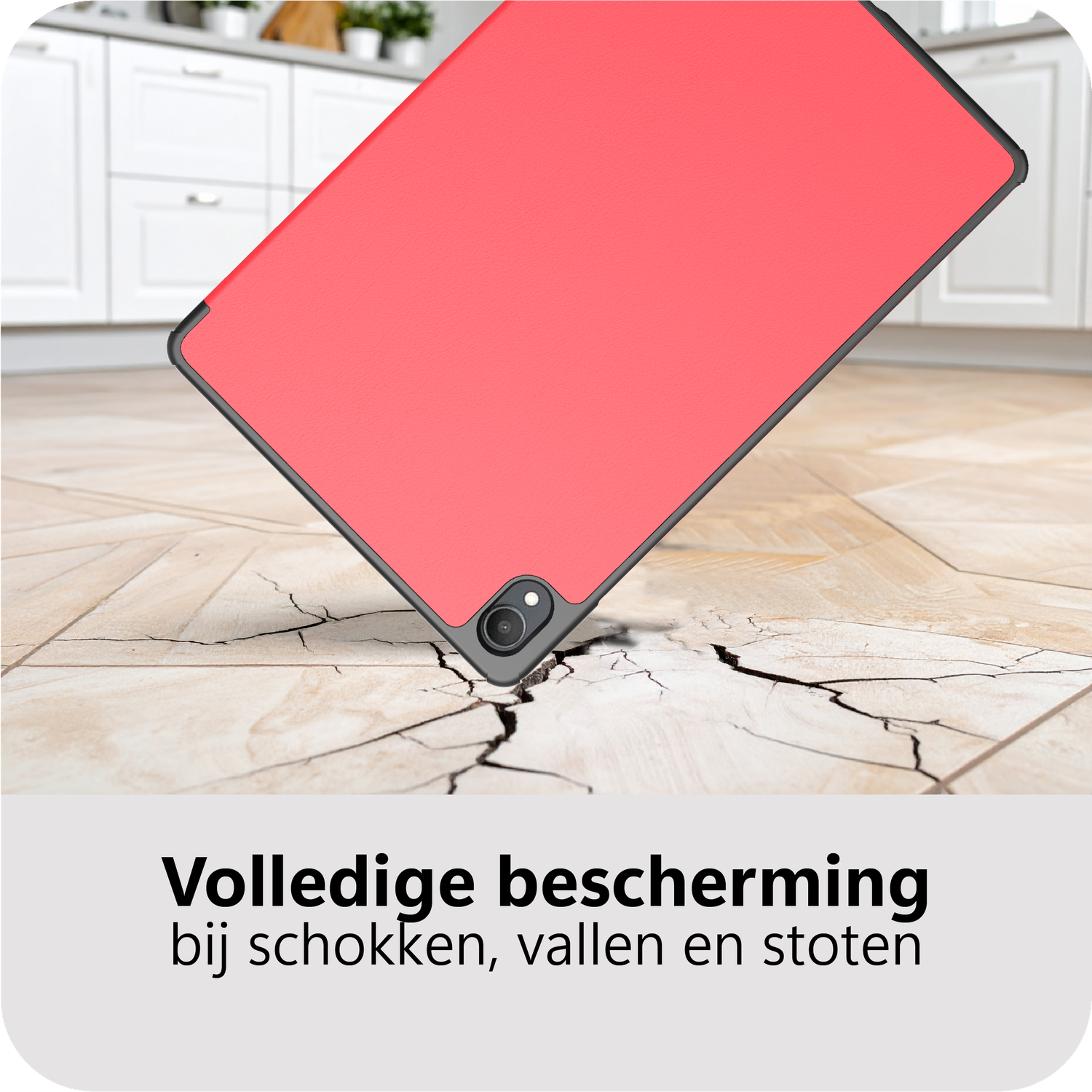 Een rode tablet valt op een gebarsten houten vloer.