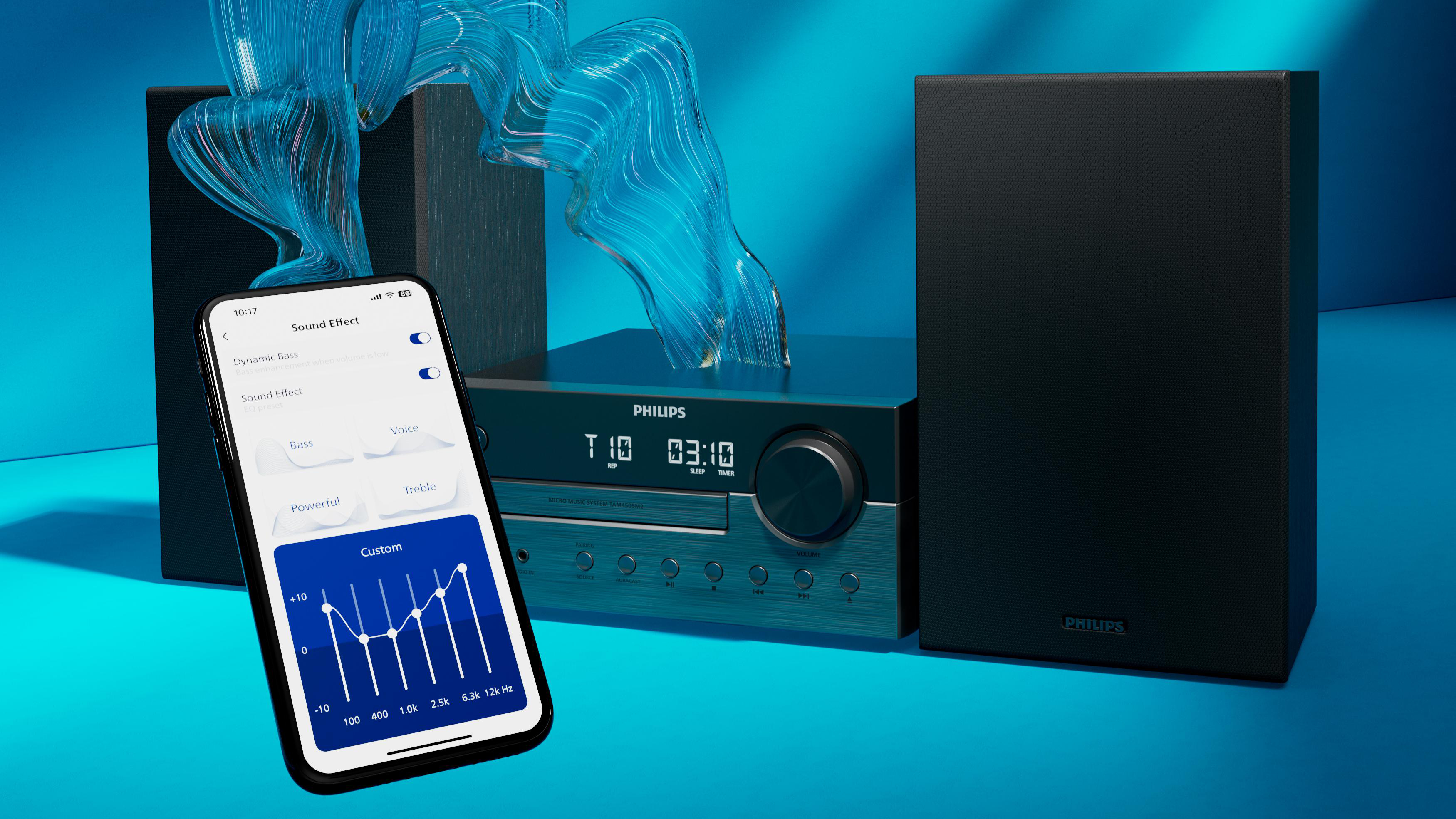 Ein Smartphone zeigt eine Equalizer-App vor einer Philips Musikanlage mit Lautsprechern.