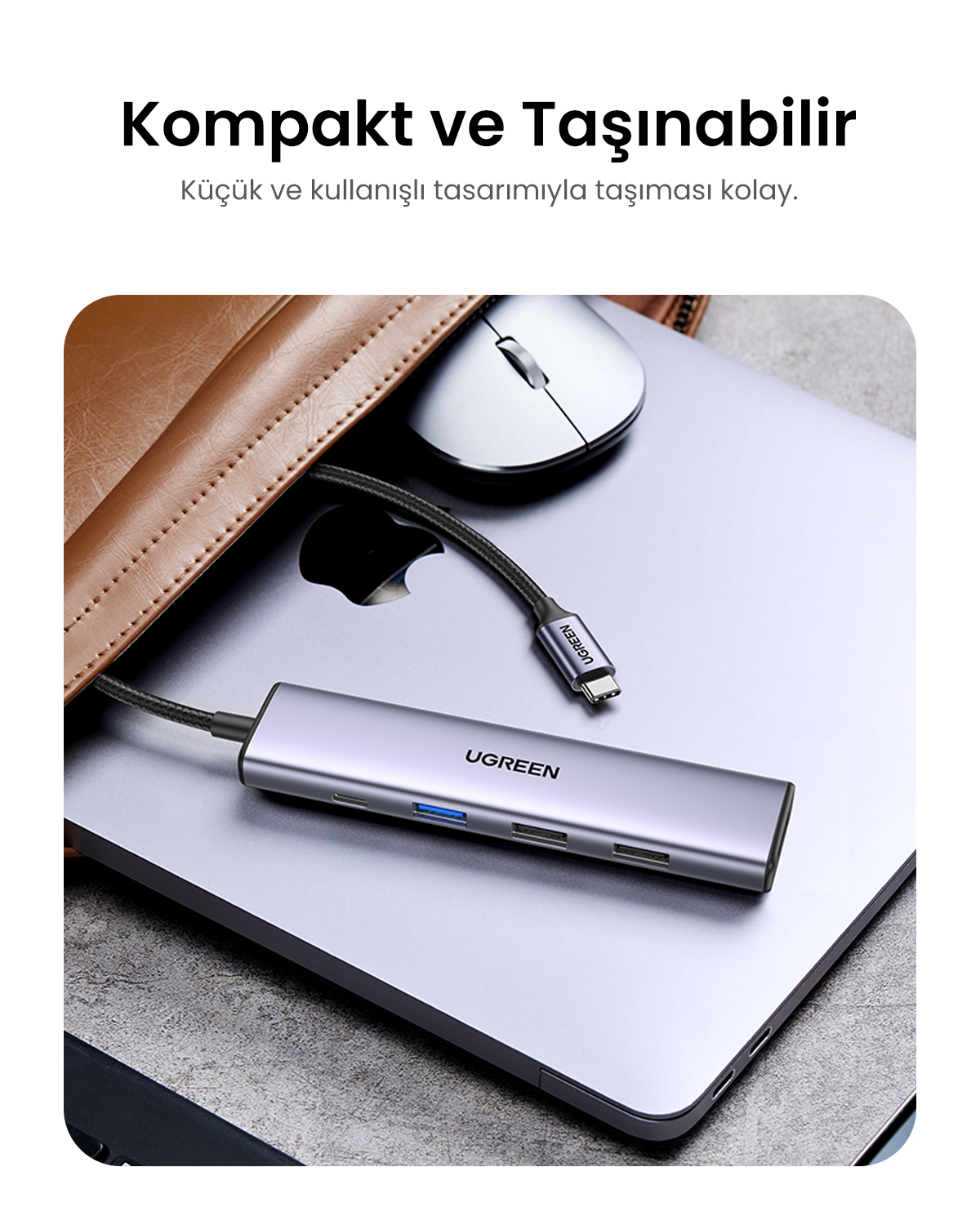 Çok portlu gri USB-C hub bir dizüstü bilgisayarın üzerinde duruyor.