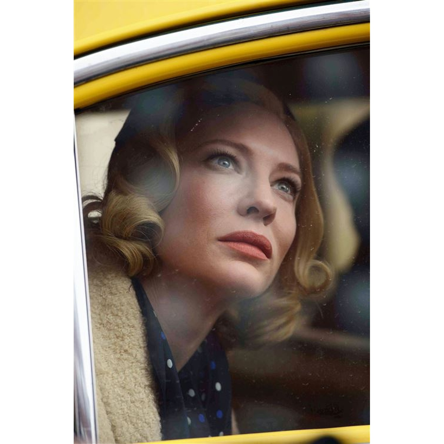 A woman with blonde hair looks out a yellow car window.