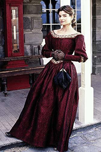 Eine Frau in einem weinroten viktorianischen Kleid steht im Freien vor einem Gebäude.