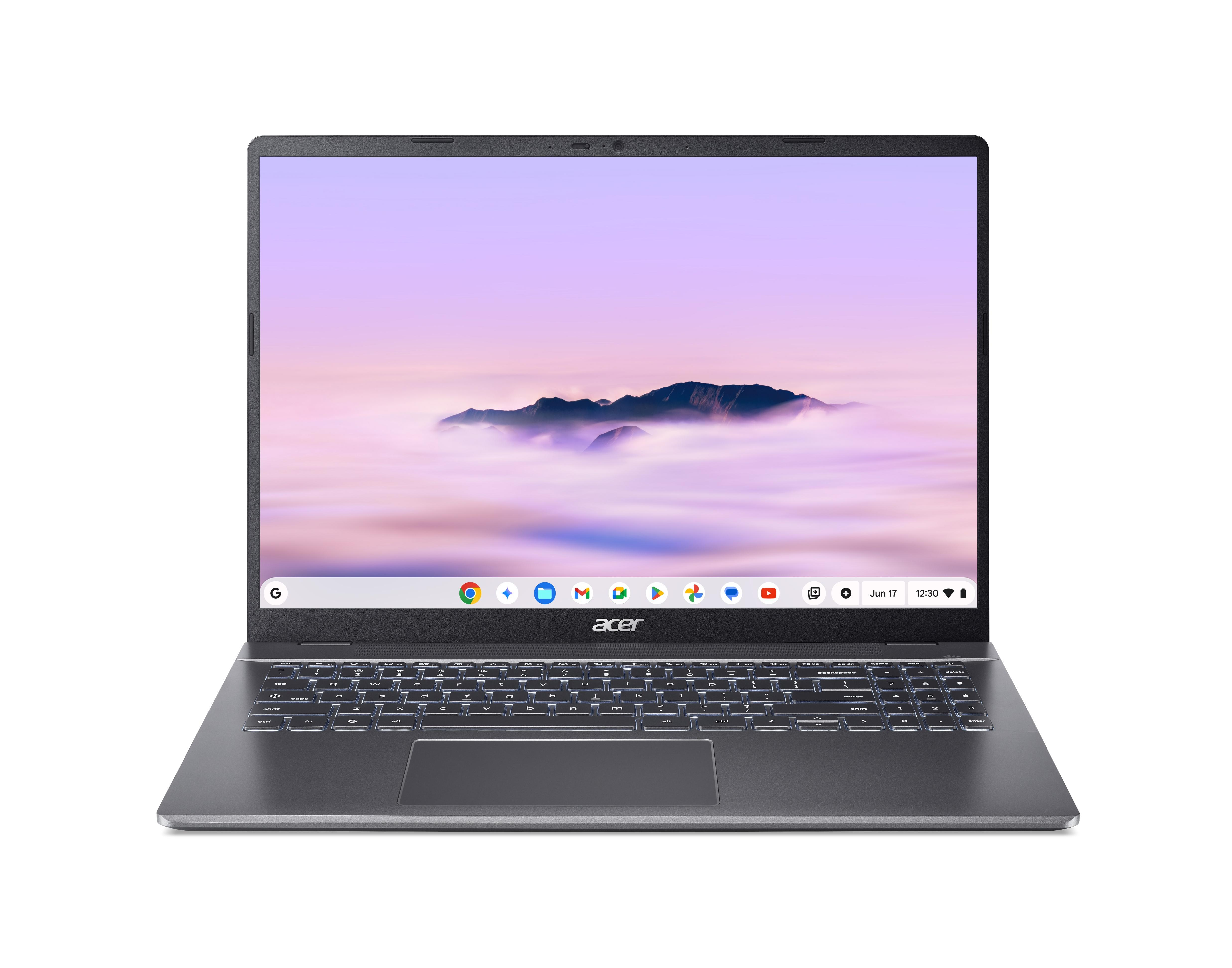 Ein dunkler Acer Laptop mit beleuchteter Tastatur und einem Bergpanorama auf dem Bildschirm.
