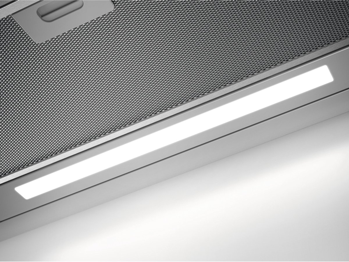 A modern range hood with a metal filter and lighting.