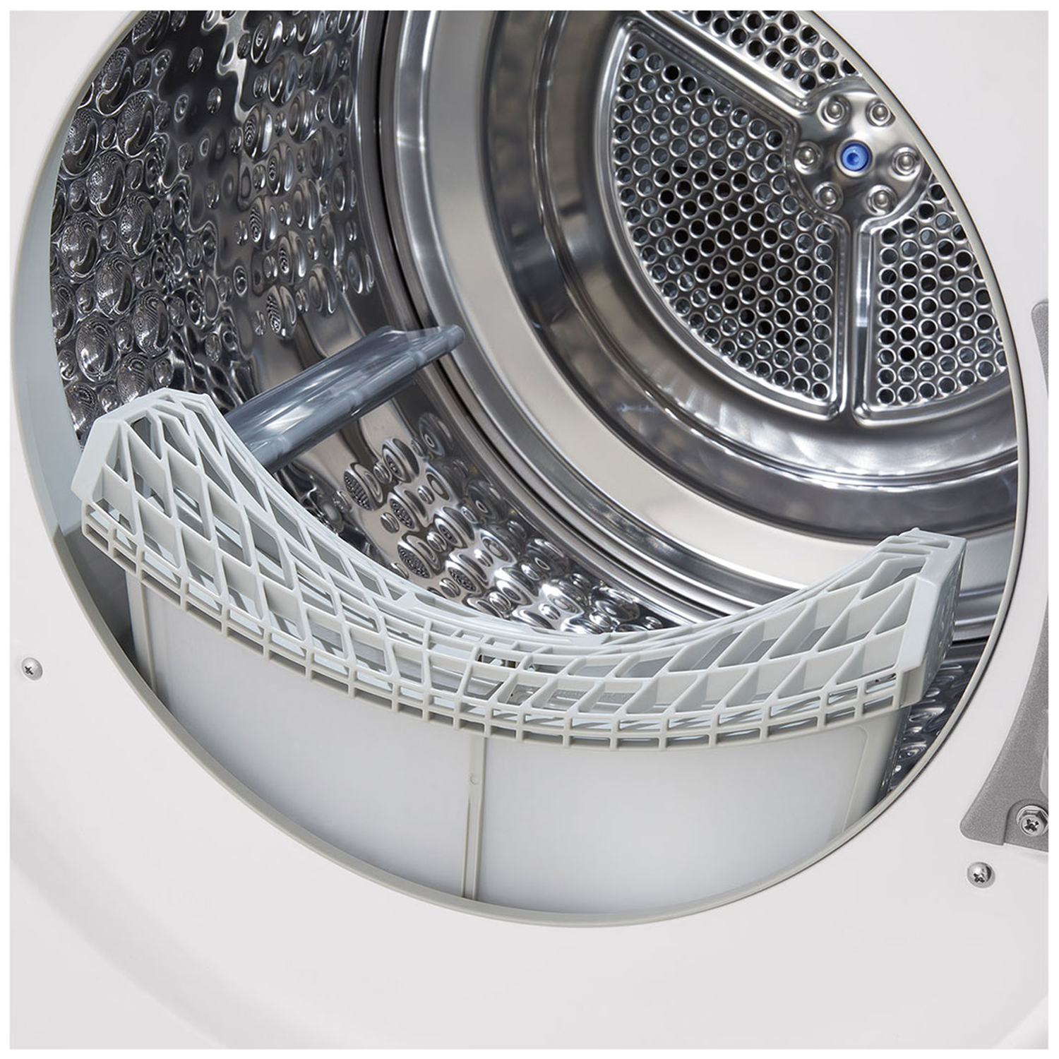 Close-up of a dryer drum with a white filter basket in the foreground.