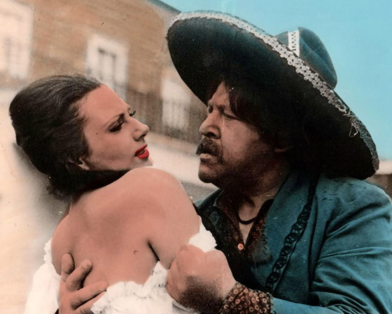 Ein Mann mit Sombrero hält eine Frau in einem weißen Kleid.