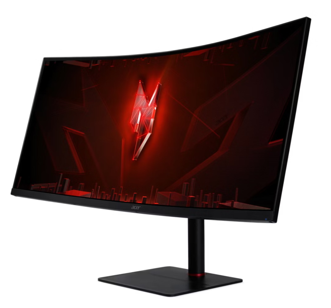 Görbített gamer monitor piros logóval és stilizált városi háttérrel.