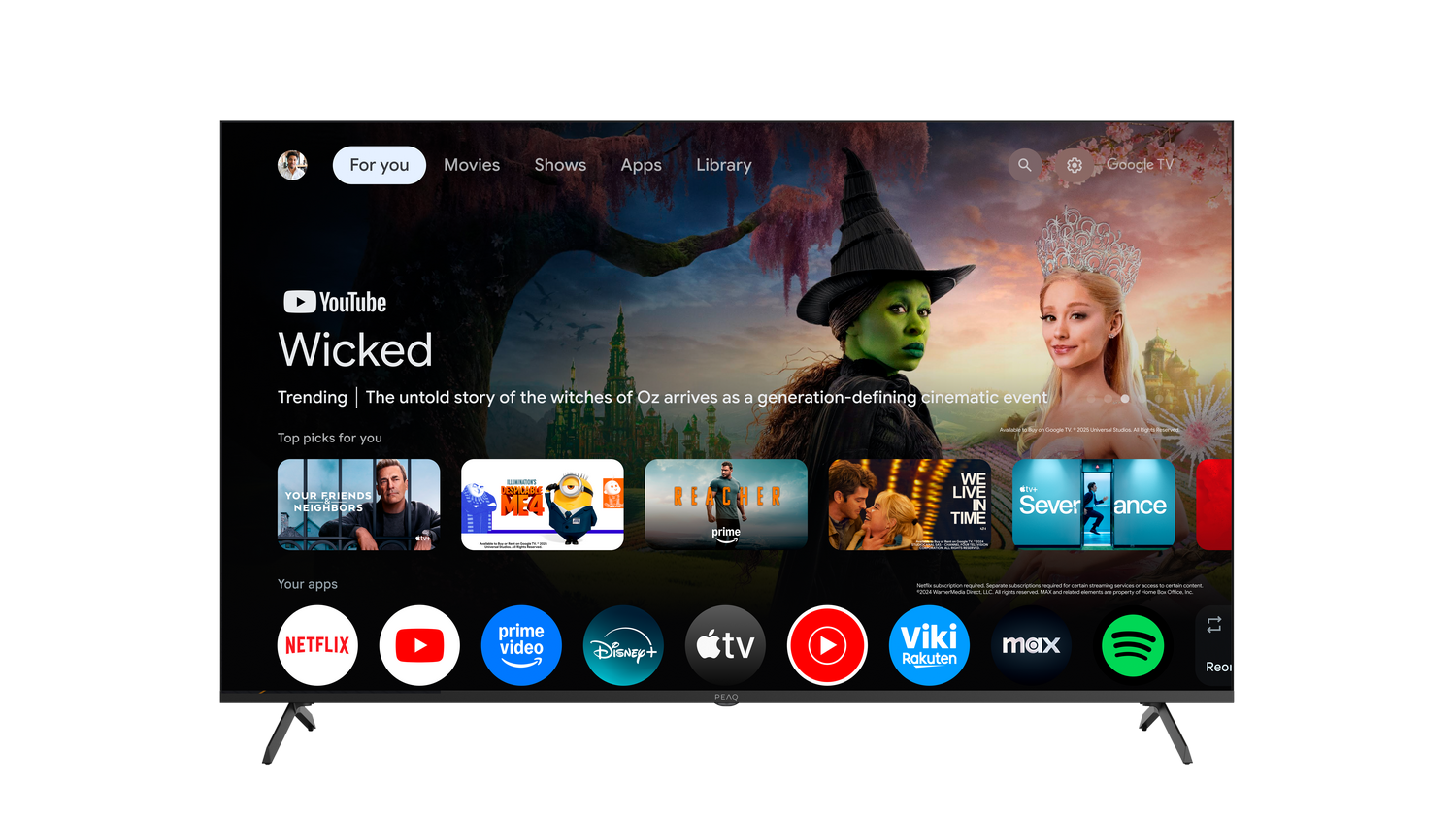 Un televisor muestra la interfaz de Google TV con la película "Wicked" y varias aplicaciones.