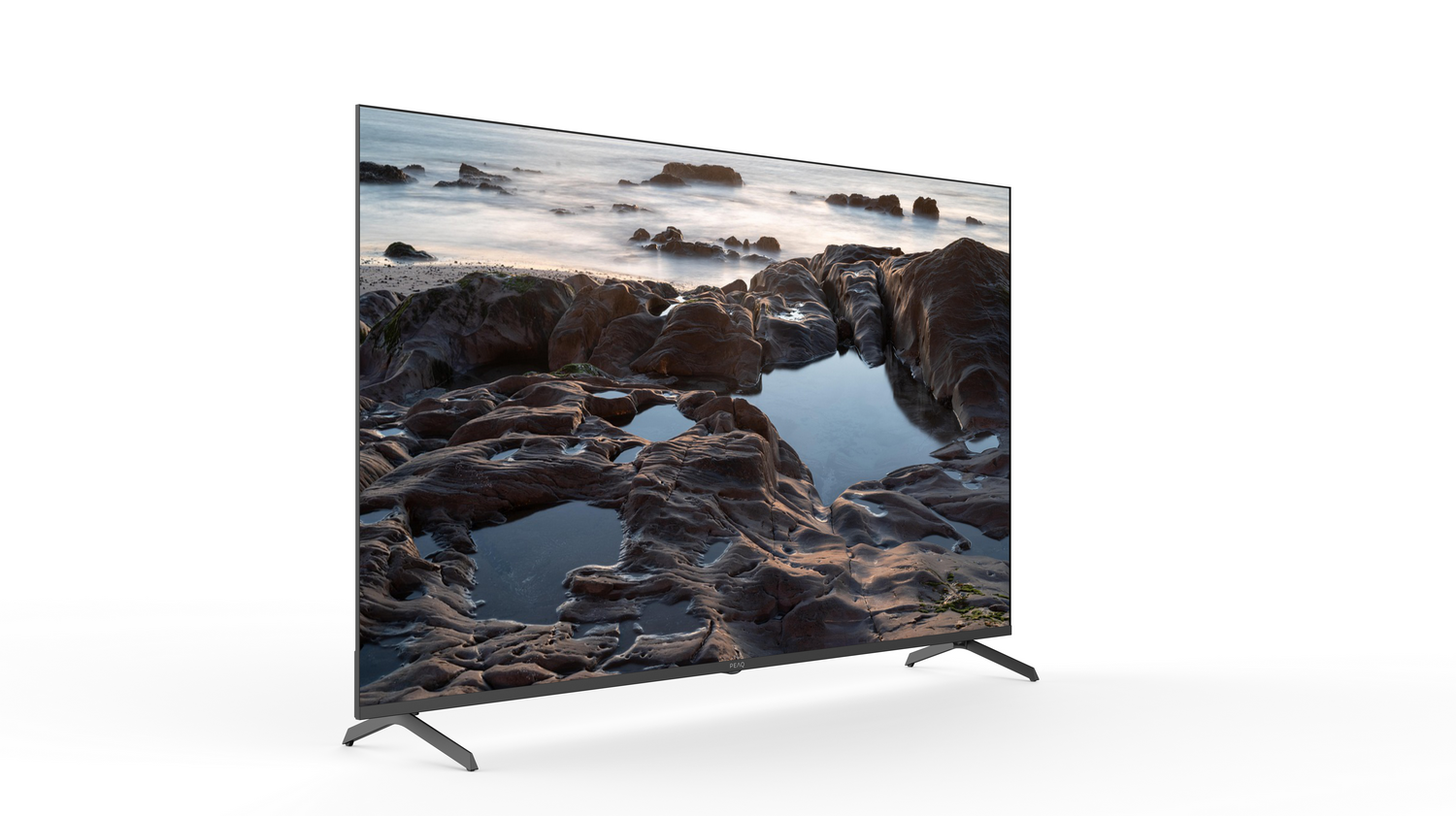 Un televisor moderno muestra una costa rocosa con charcos de marea y el mar al fondo.