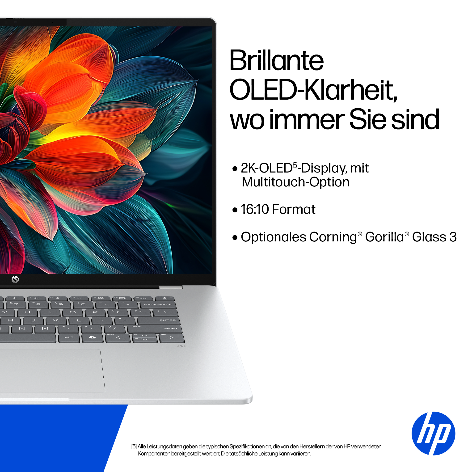 Ein silberner Laptop mit einem bunten OLED-Bildschirm, der Blumen zeigt.