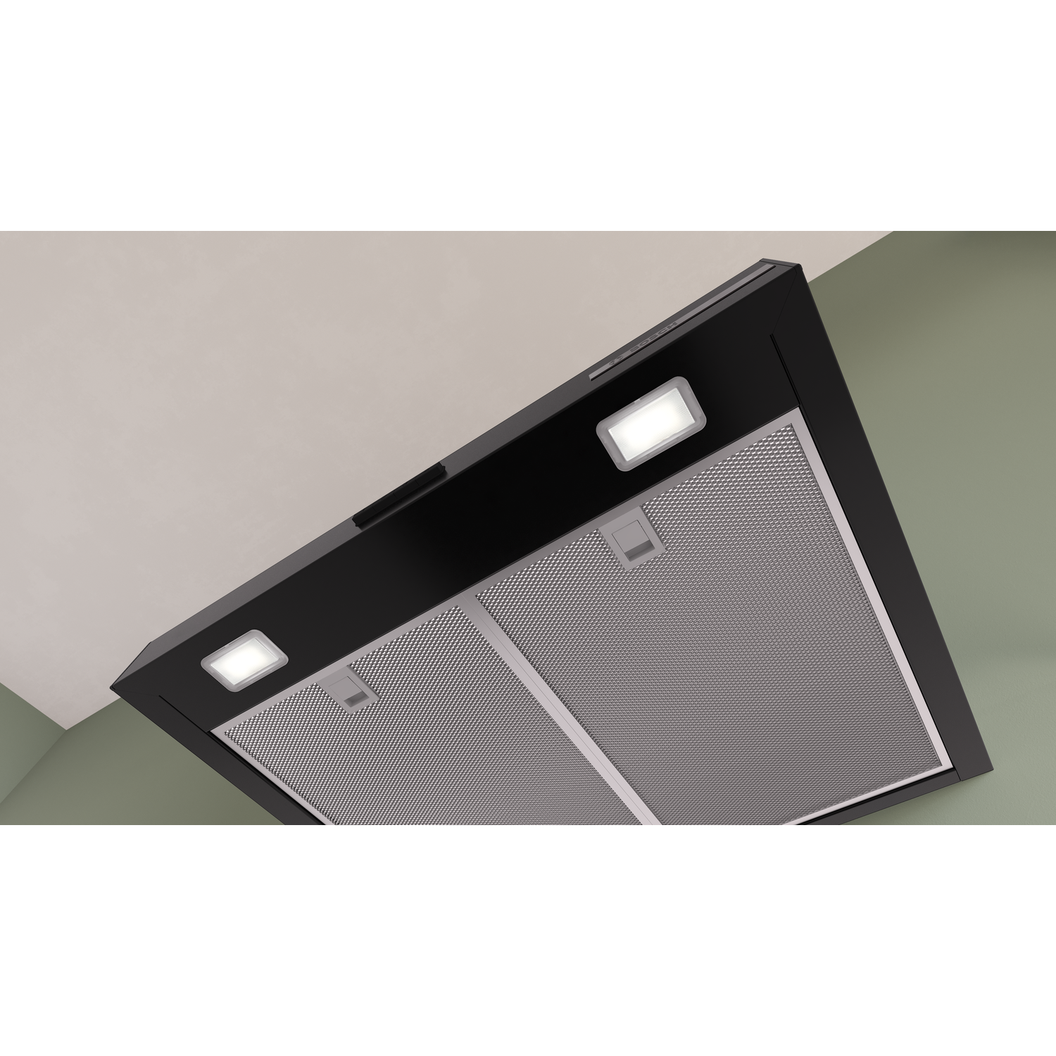 Black range hood with lights and metal filters, against a green wall.