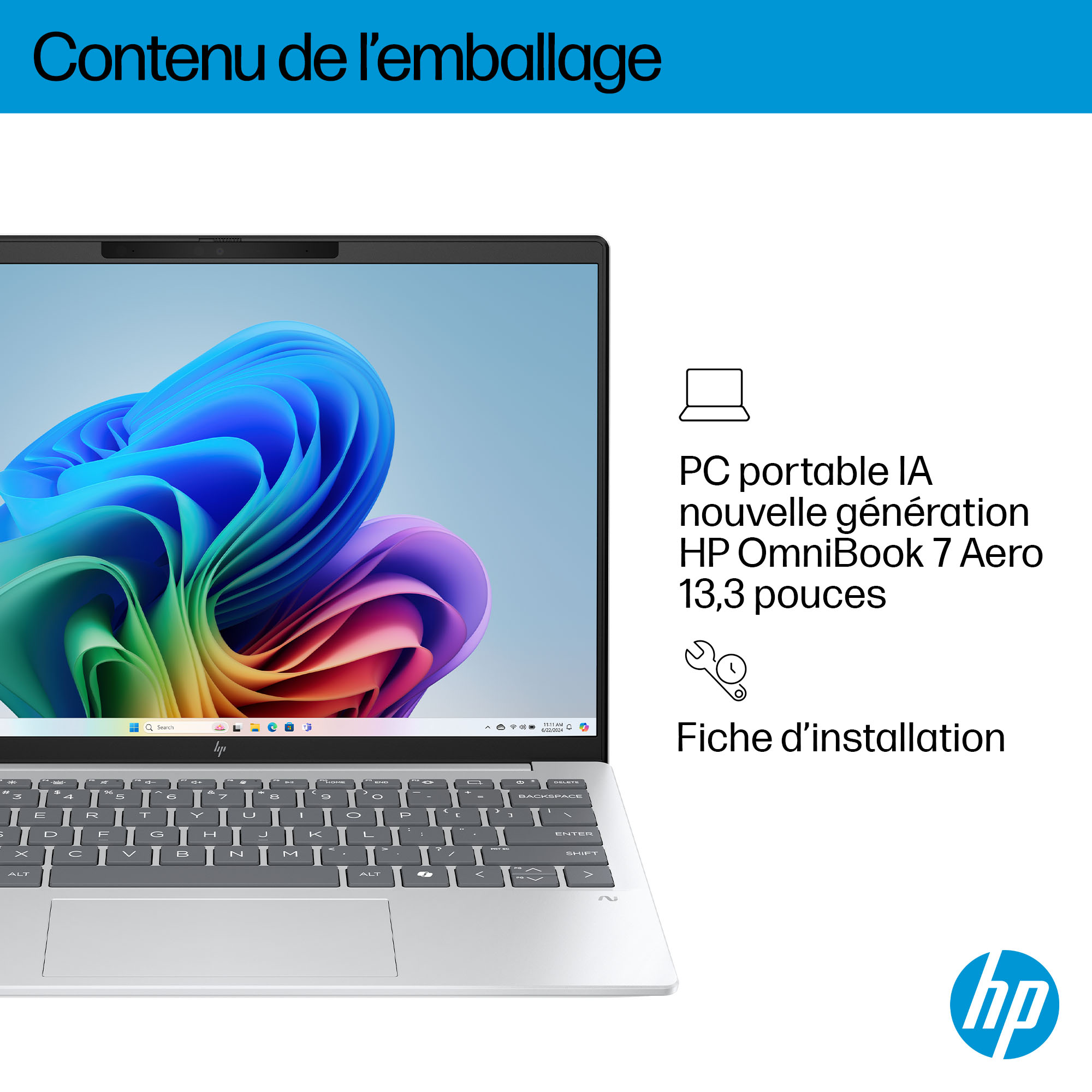 Un ordinateur portable argenté affichant un fond coloré Windows et clavier.