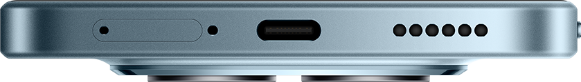 Közeli kép az USB-C portról és hangszóró lyukakról egy szürke telefonon.