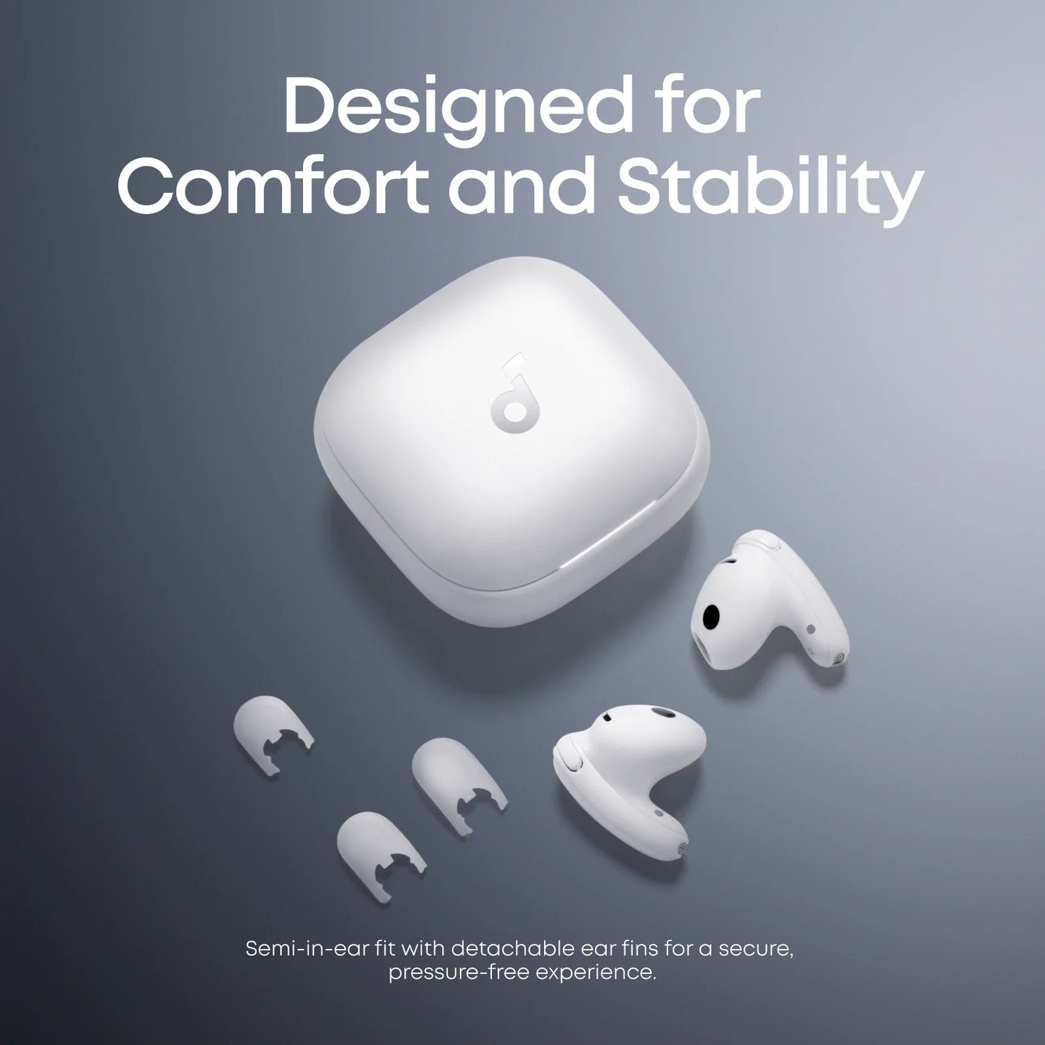 A white charging case with earbuds and ear fins on a gray background.