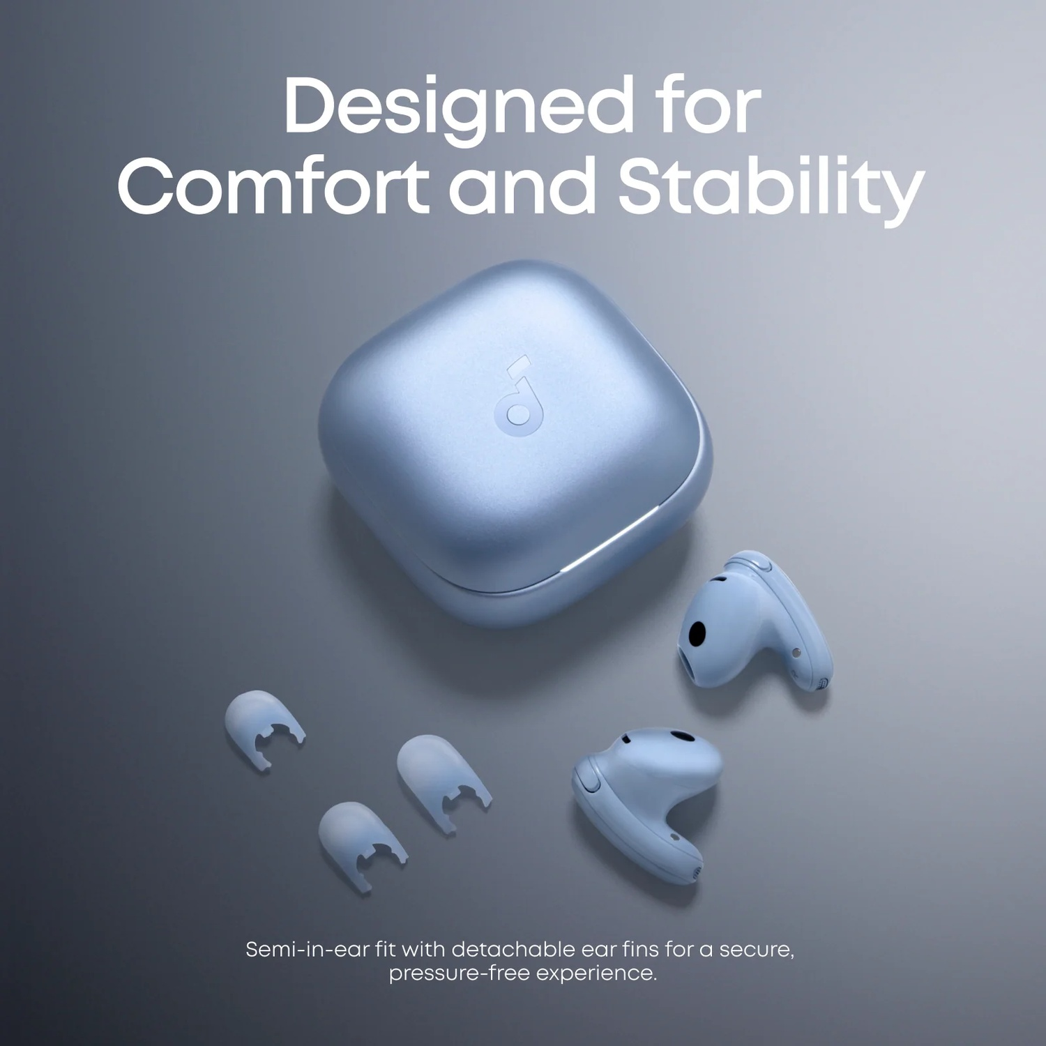 A light blue charging case with earbuds and extra ear fins on a gray background.