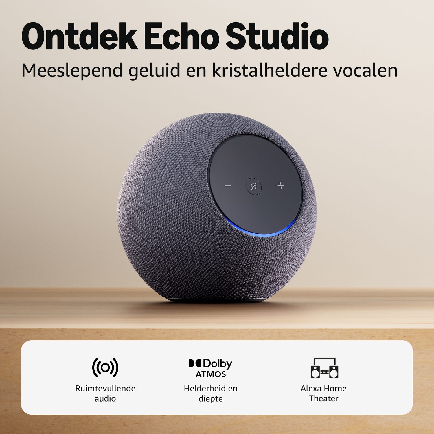 Gray Echo Studio speaker with control panel and blue light on wood.