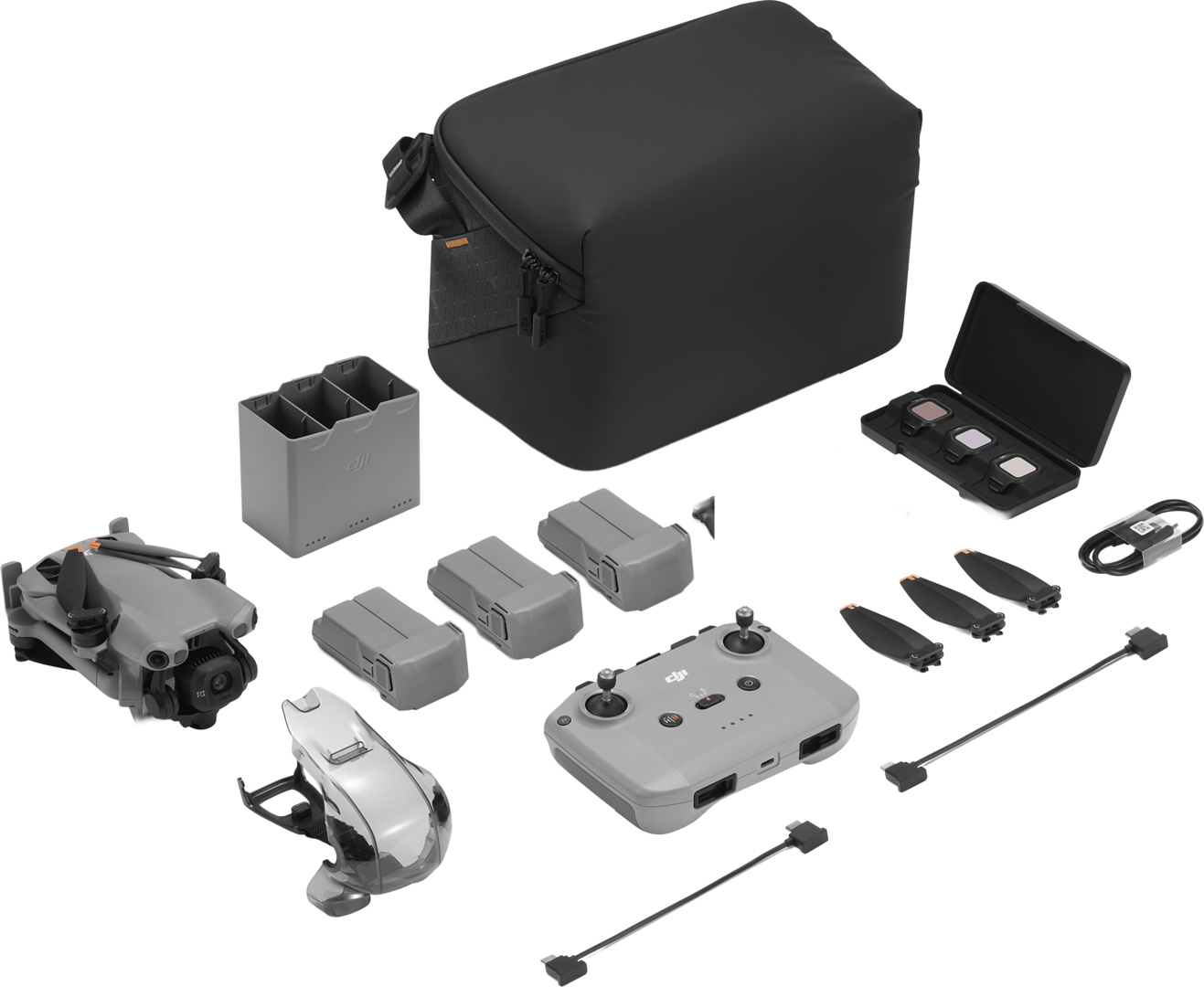 Kit drone DJI grigio con borsa, telecomando, batterie, eliche e cavi.