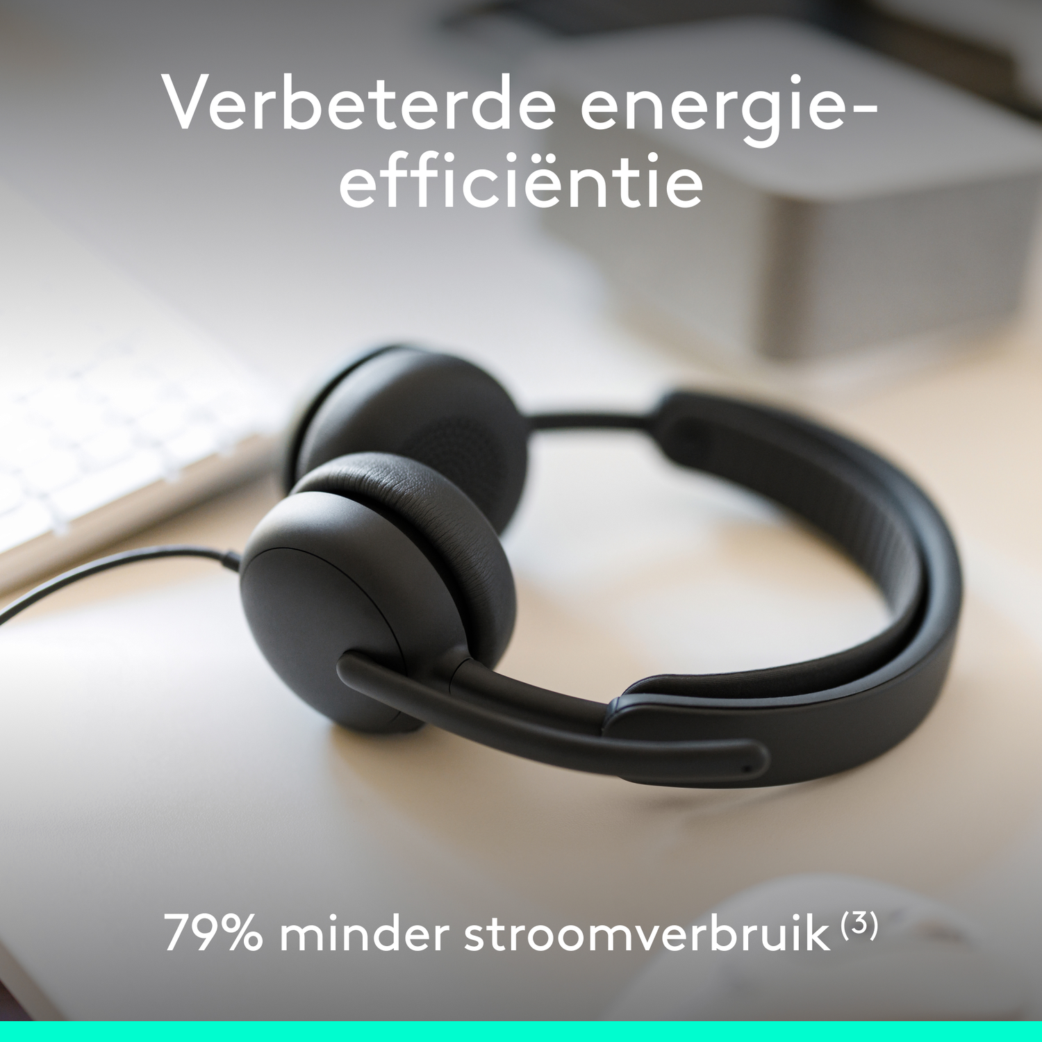 Black headphones on a desk with text about energy efficiency.