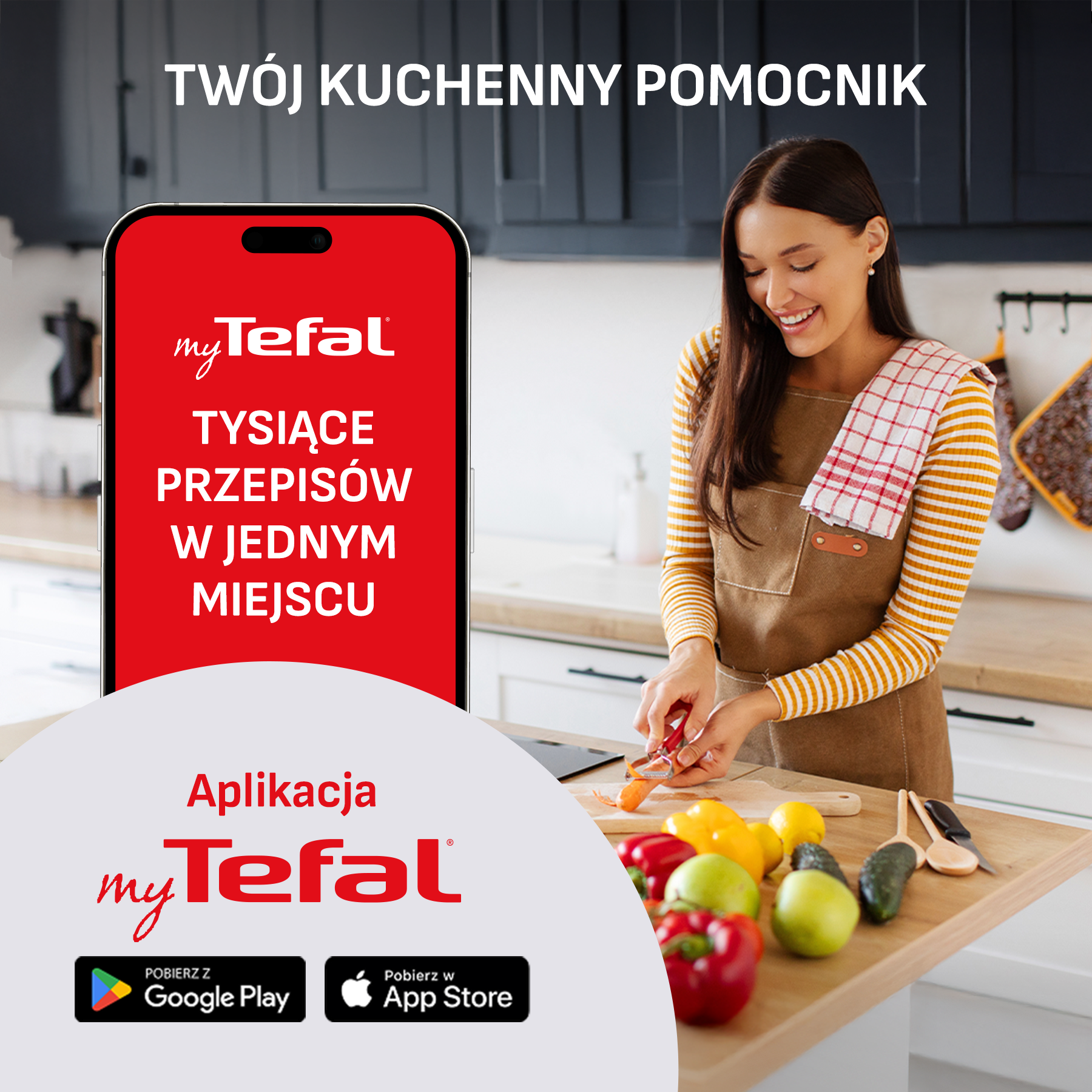 Kobieta obiera marchewkę w kuchni, obok owoców i warzyw. Reklamowana jest aplikacja.