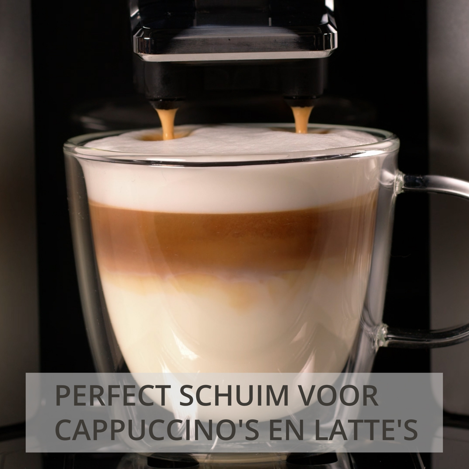 A coffee machine prepares a latte macchiato in a glass cup.