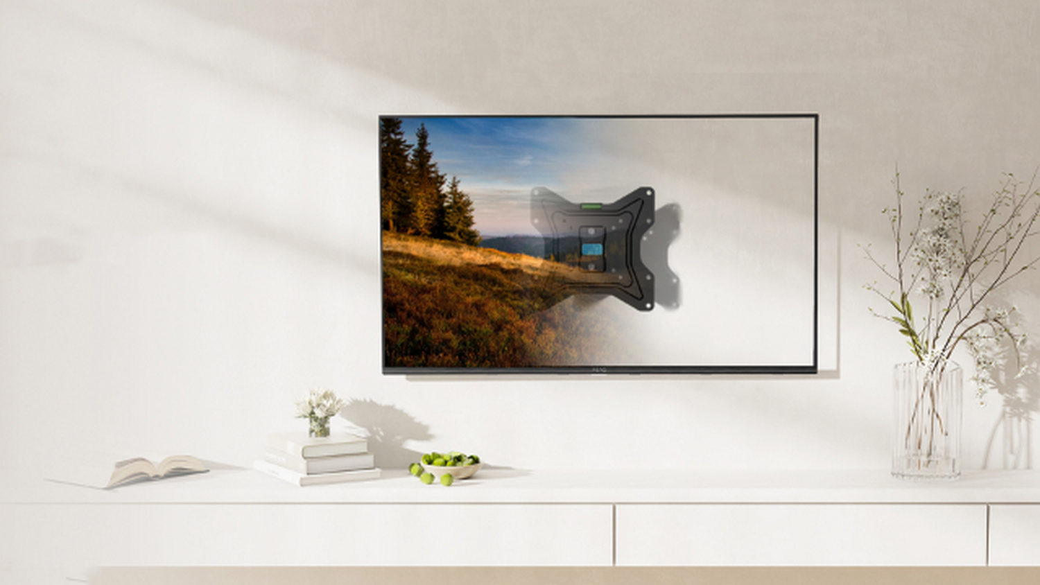 Un soporte de pared para TV negro con herramientas en un televisor que muestra un paisaje.