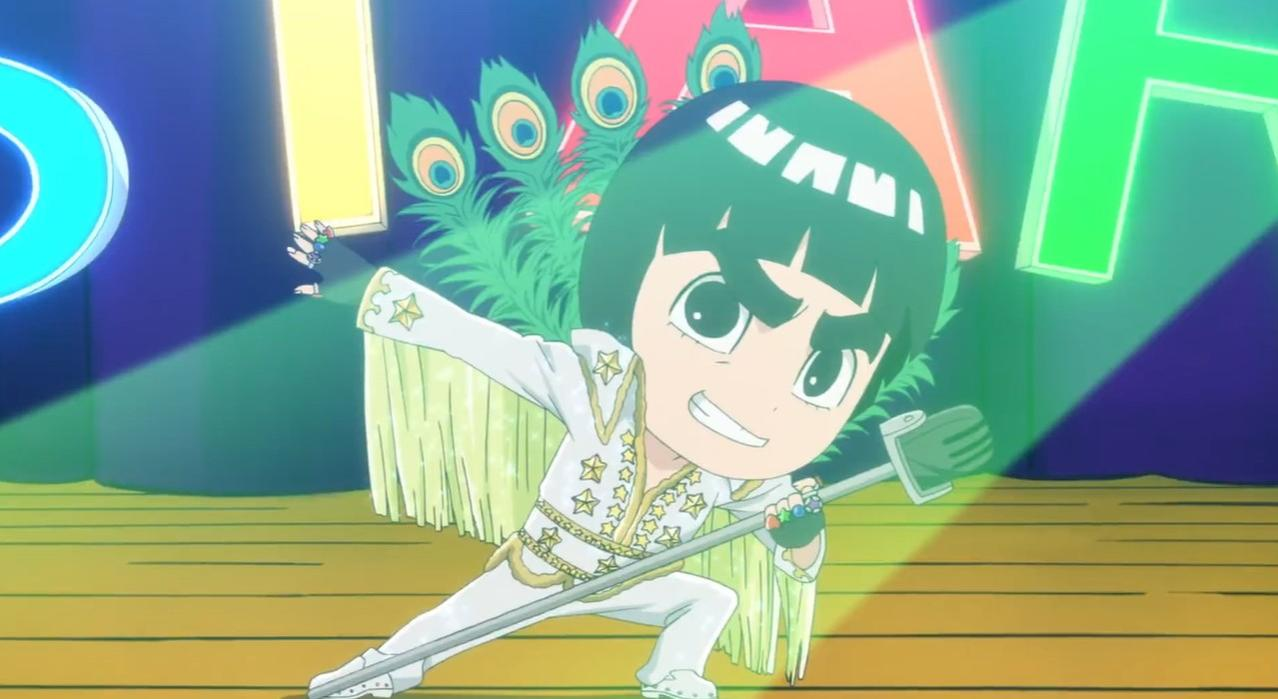 Ein Anime-Charakter in weiem Anzug mit Sternen steht auf einer Böhne.