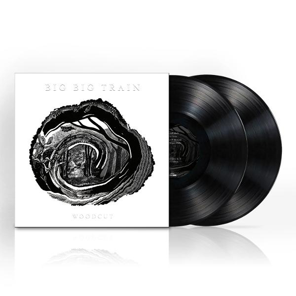 Zwei schwarze Schallplatten liegen neben einem Plattencover mit "BIG BIG TRAIN WOODCUT" Schriftzug.