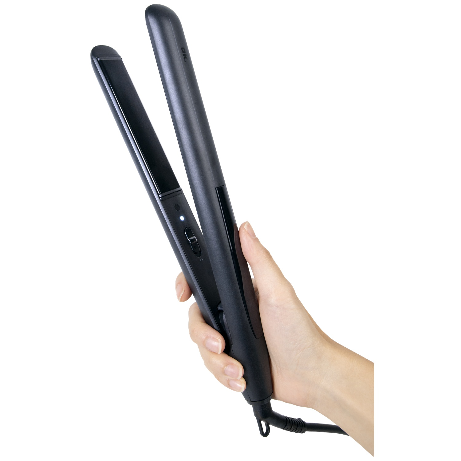 A hand holds a black hair straightener with open plates.