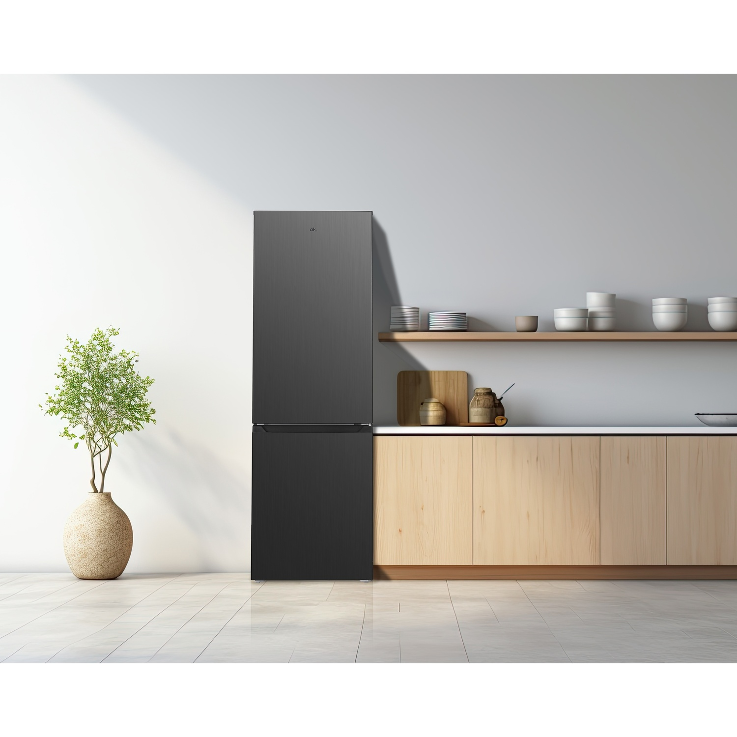A black refrigerator stands in a modern kitchen next to a potted plant.