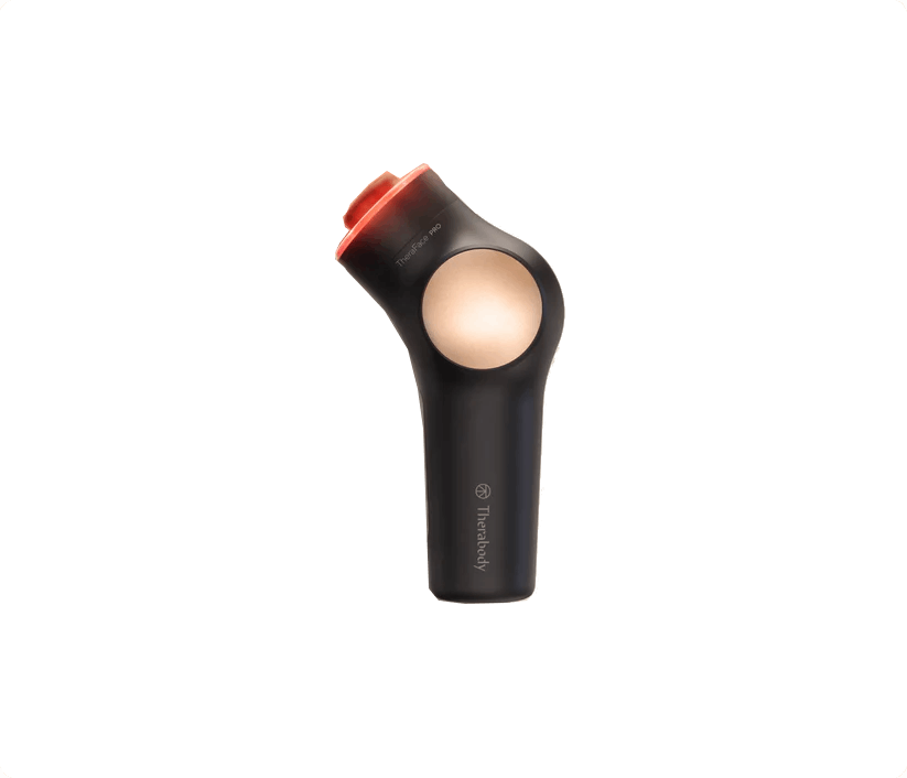 Dispositivo de masaje gris oscuro con accesorio rojo y círculo de luz dorado.